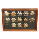 A collection of late 20th Century American enamelled sheriff and deputy sheriff badges to include