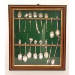 A collection of silver commemorative spoons to include an Enfield rifle shape and other silver and