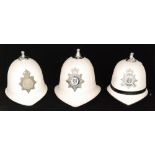 Two white duty policeman's helmets for the Isle Of Man, another for Thames Valley,