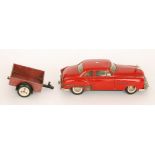 A red Schuco Ingenico clockwork car No 5311 together with a Bakelite trailer No 5330 (2)
