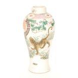 An early 20th Century Chinese vase decorated with a tiger prowling within a landscape,