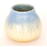 A small Ruskin Pottery vase of compressed ovoid form with a blue to yellow crystalline glaze,