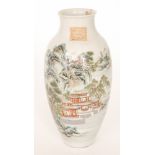 An early 20th Century Chinese vase decorated with a Chinoiserie landscape depicting a temple