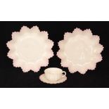 Two late 19th Century Belleek shallow dishes of flower head form with fluted edges and a pink tint