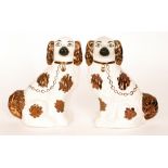 A pair of Victorian Staffordshire mantel spaniels with bronze lustre painted decoration,