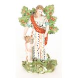 A 19th Century Staffordshire figure modelled as a lady in patterned dress and red robe stood before