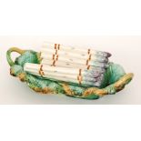 A late 19th to early 20th Century majolica asparagus dish, the rectangular twin handled base formed