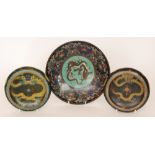 A matched pair of modern cloisonne shallow bowls each decorated with a scrolling dragon to a black