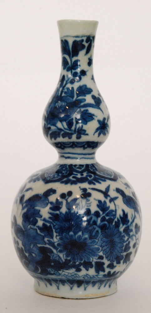 A late 19th Century continental double gourd vase decorated in blue and white with birds and