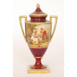 An early 20th Century pedestal vase and cover decorated with a hand tinted rectangular cartouche