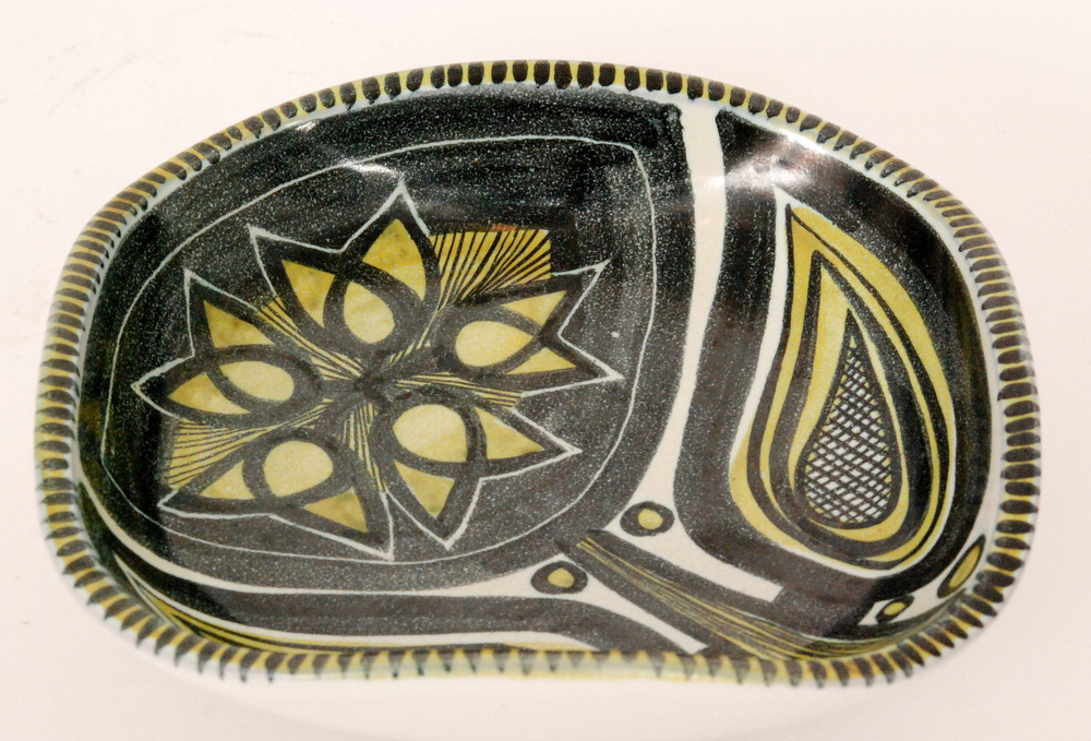 A post war Danish studio pottery bowl of rounded square form decorated with a hand painted stylised