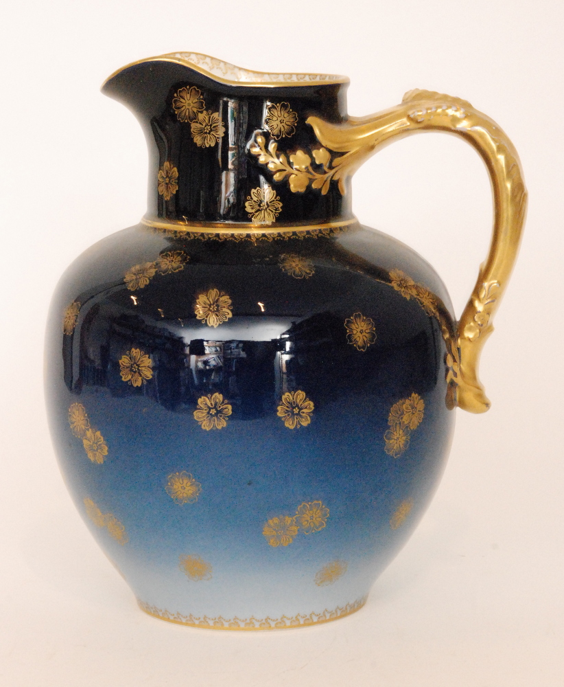 An early 20th Century Haviland & Co Limoges jug decorated in a tonal blue with a gilt applied