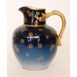 An early 20th Century Haviland & Co Limoges jug decorated in a tonal blue with a gilt applied