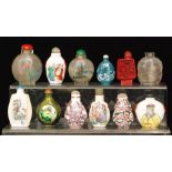 A collection of eleven Chinese painted glass and porcelain snuff bottles.