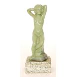 A 1930s Art Deco cast metal statue formed as a nude lady sat on a rock with her arms behind her