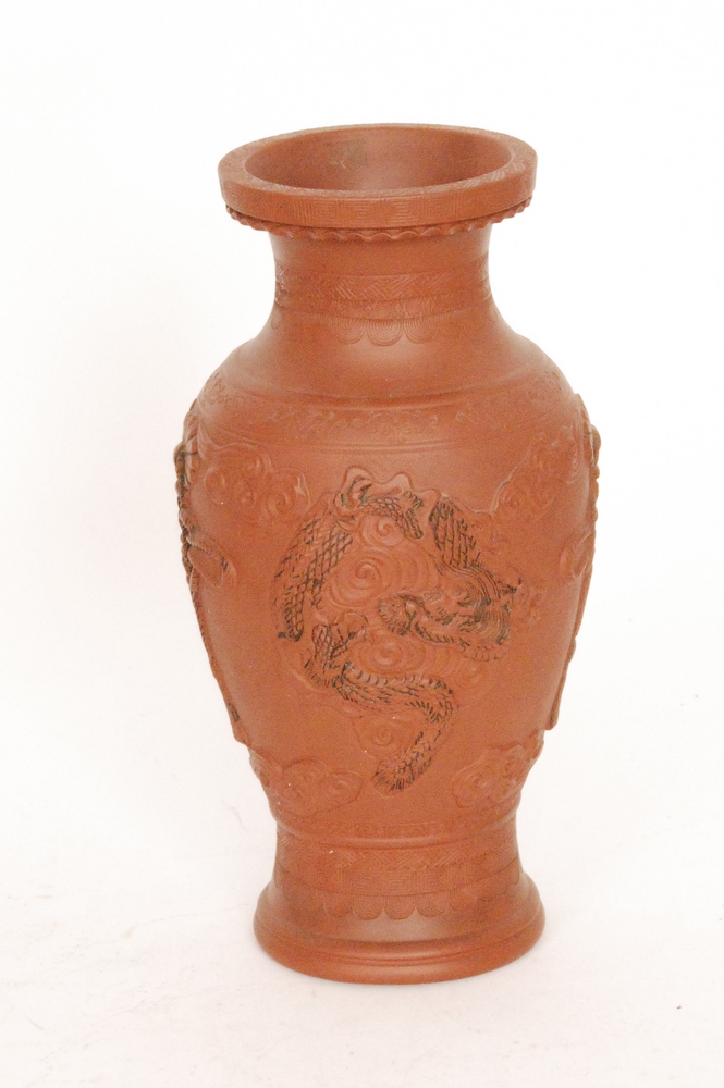 A 20th Century Japanese terracotta vase of shouldered ovoid form with collar neck, relief moulded