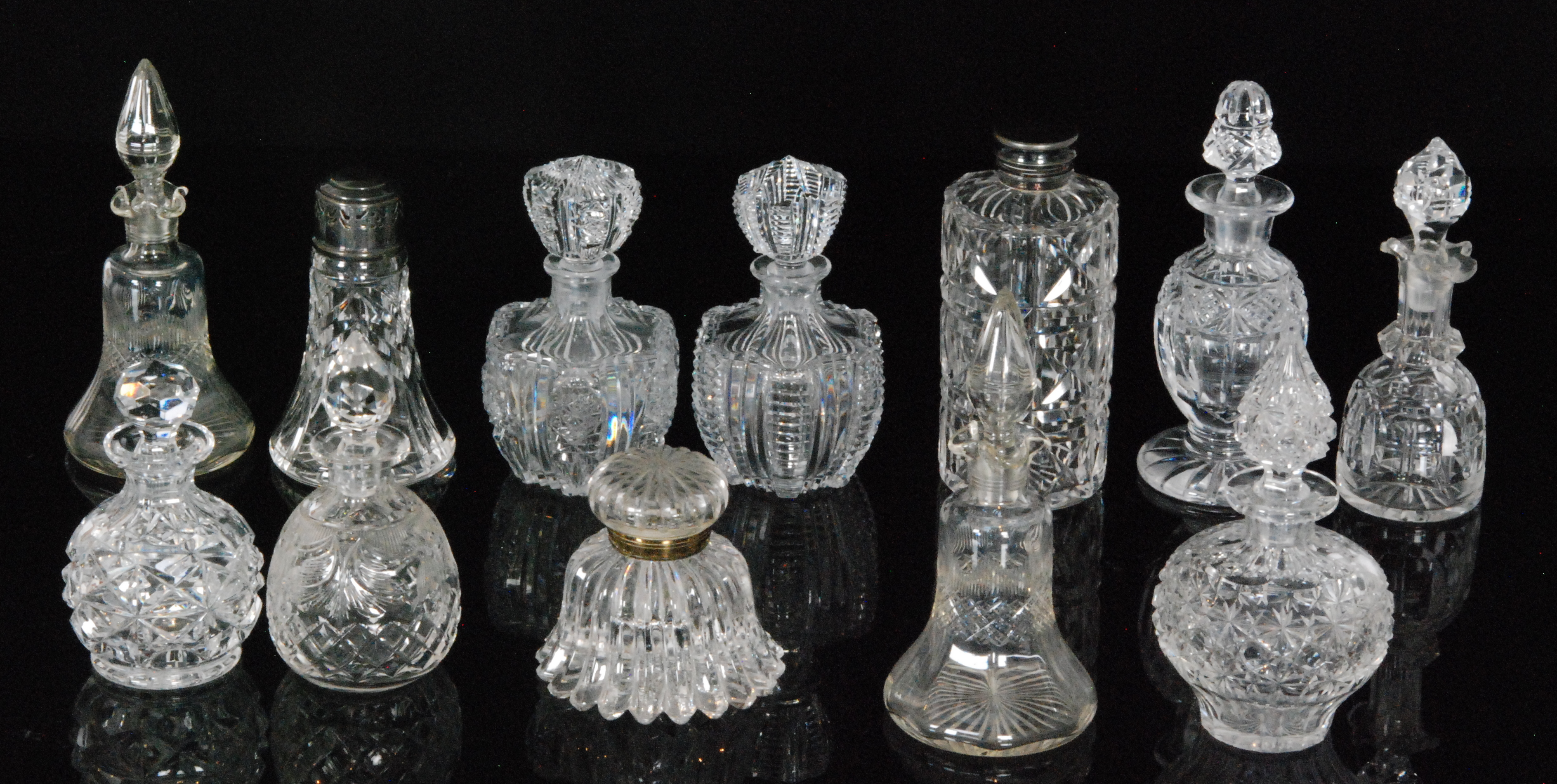 A group of John Walsh Walsh crystal glass comprising nine varying scent bottles, an inkwell,