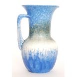 A Ruskin Pottery flower jug decorated in a blue to green to white to blue crystalline glaze,