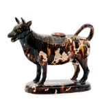 A late 18th Century Staffordshire Neale Pottery cow creamer and cover decorated in an all over