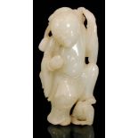 A late 19th and early 20th Century Chinese republic period carved jade figure of a monk with left