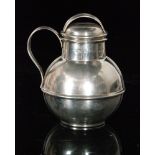 An early 20th Century hallmarked silver Jersey style jug and cover of plain form, height 11cm,