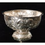 A 19th Century Dutch silver small pedestal bowl decorated with rural scenes below beaded borders,