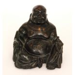 A small carved wooden buddha in the seated position height 13cm