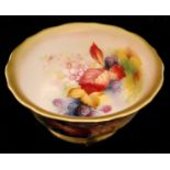 A Royal Worcester footed bowl decorated by Kitty Blake with hand painted autumnal fruits and