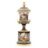 A late 19th to early 20th Century continental pedestal vase and cover decorated in the manner of