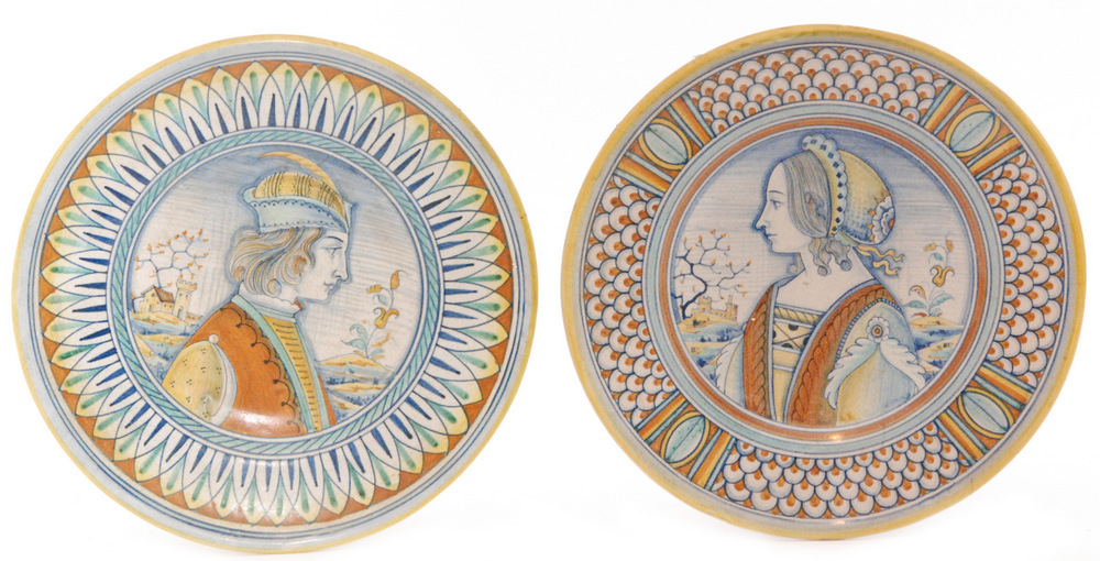 A pair of late 19th Century maiolica plates decorated with a hand painted portrait of a young