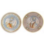 A pair of late 19th Century maiolica plates decorated with a hand painted portrait of a young