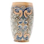 A late 19th Century Doulton Lambeth beaker decorated in the round with a repeat foliate pattern