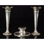 A pair of hallmarked silver trumpet vases of plain form, circular foot rising to crimped borders,