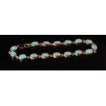 A modern 9ct hallmarked opal bracelet comprising of sixteen oval collar set stones terminating in