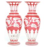 A pair of late 19th Century Bohemian glass vases, each of footed shouldered form with flared neck,