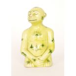An early 20th Century model of a seated mythical monkey type creature glazed in yellow with green