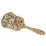 An early 20th Century Chinese hand mirror of cartouche form the back inset with a jade coloured