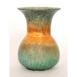 A Ruskin Pottery vase of globe and shaft form decorated in a streaked crystalline glaze with green