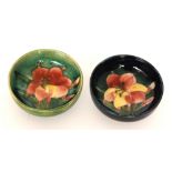 Two small Moorcroft footed bowls decorated in the African Lily pattern,