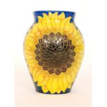 A Dennis China Works vase decorated to a design by Sally Tuffin with two sunflowers against a blue