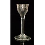 An 18th Century drinking glass circa 1740, the ogee bowl with engraved border above basal fluting,