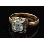 A 9ct hallmarked aquamarine and diamond cluster ring,