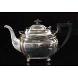 An Edwardian hallmarked silver teapot of squat form with canted corners and gadrooned border