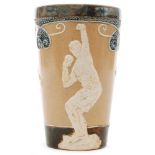 An early 20th Century Doulton Lambeth beaker decorated with three relief moulded sportsmen - one