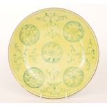 A 19th Century Chinese plate of circular dish form decorated with green mon roundels over a yellow