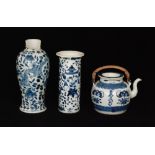 A late 19th to early 20th Century Chinese cylinder vase decorated in blue and white with two