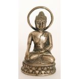 A small seated Buddha meditating in the dhyanasana pose,