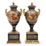 A pair of late 19th to early 20th Century continental pedestal vase and covers each decorated with