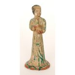 A Tang dynasty style terracotta or red clay figure modelled as a standing woman attendant,