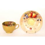 A matched Royal Worcester Fallen Fruits cabinet teacup and saucer,